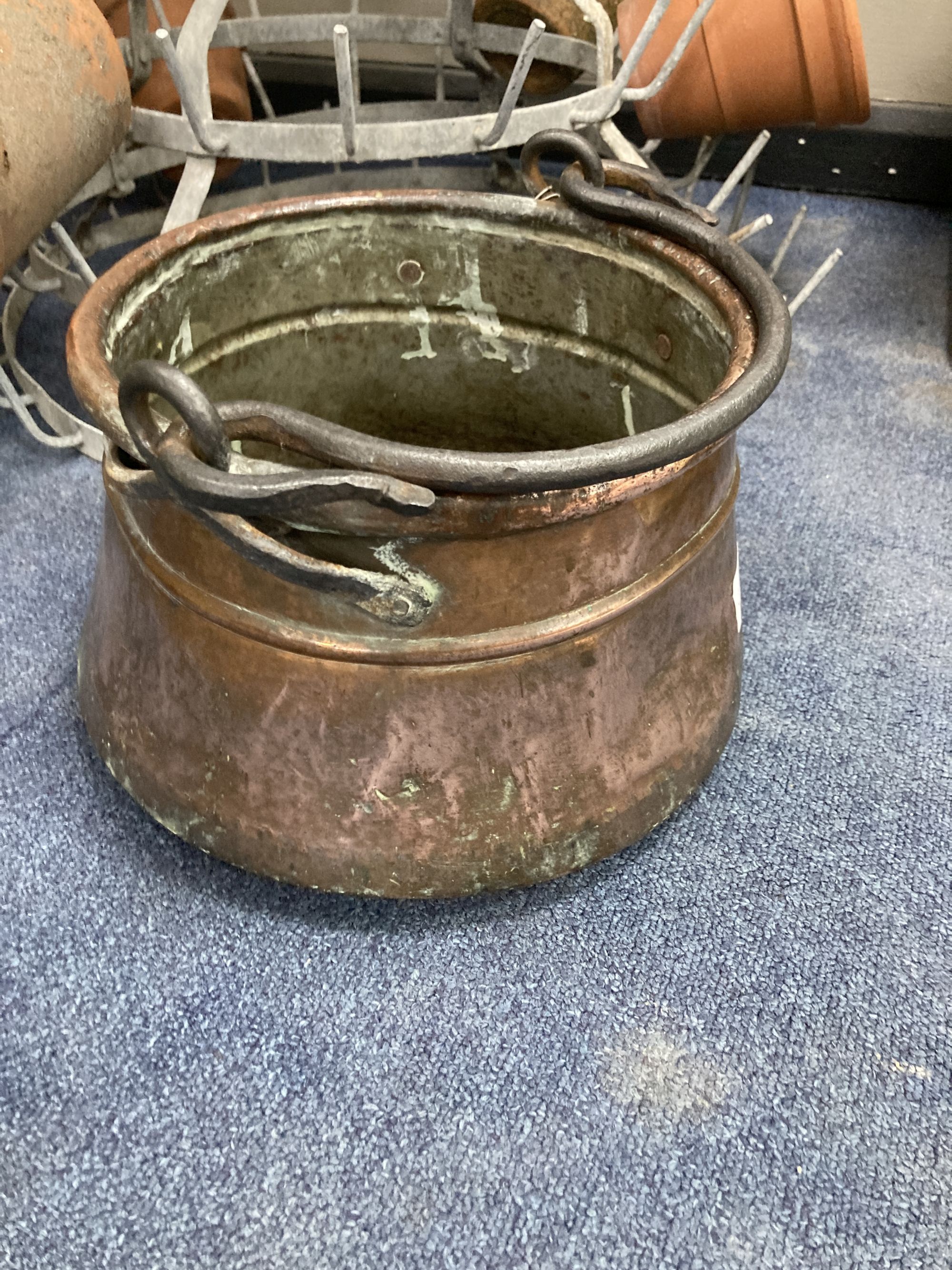 A French metal terracotta pot holder, height 102cm with assorted terracotta pots and an Eastern copper pan, height 21cm